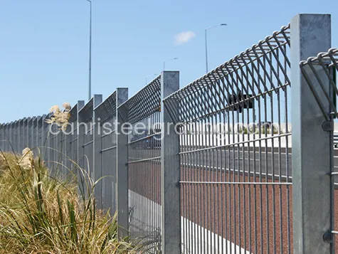 Galvanized roll top fence used to divide the road and the wasteland